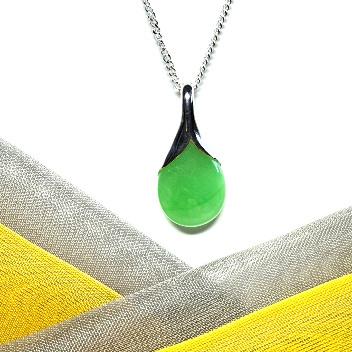 Real green jade necklace in a teardrop or pear shaped, timeless designed pendant with a chain