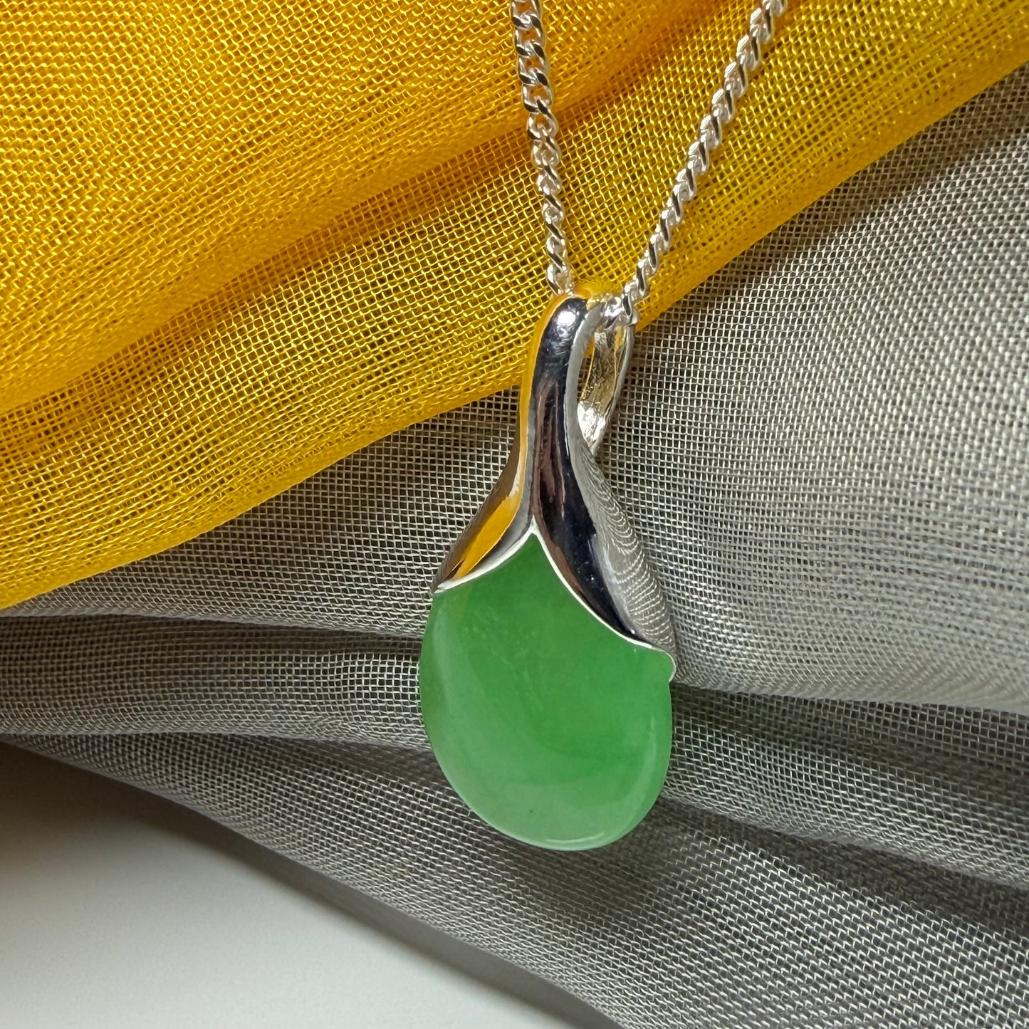 Real green jade necklace in a teardrop or pear shaped, timeless designed pendant with a chain