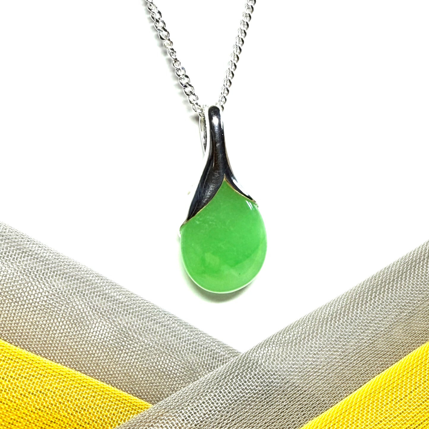 Real green jade necklace in a teardrop or pear shaped, timeless designed pendant with a chain