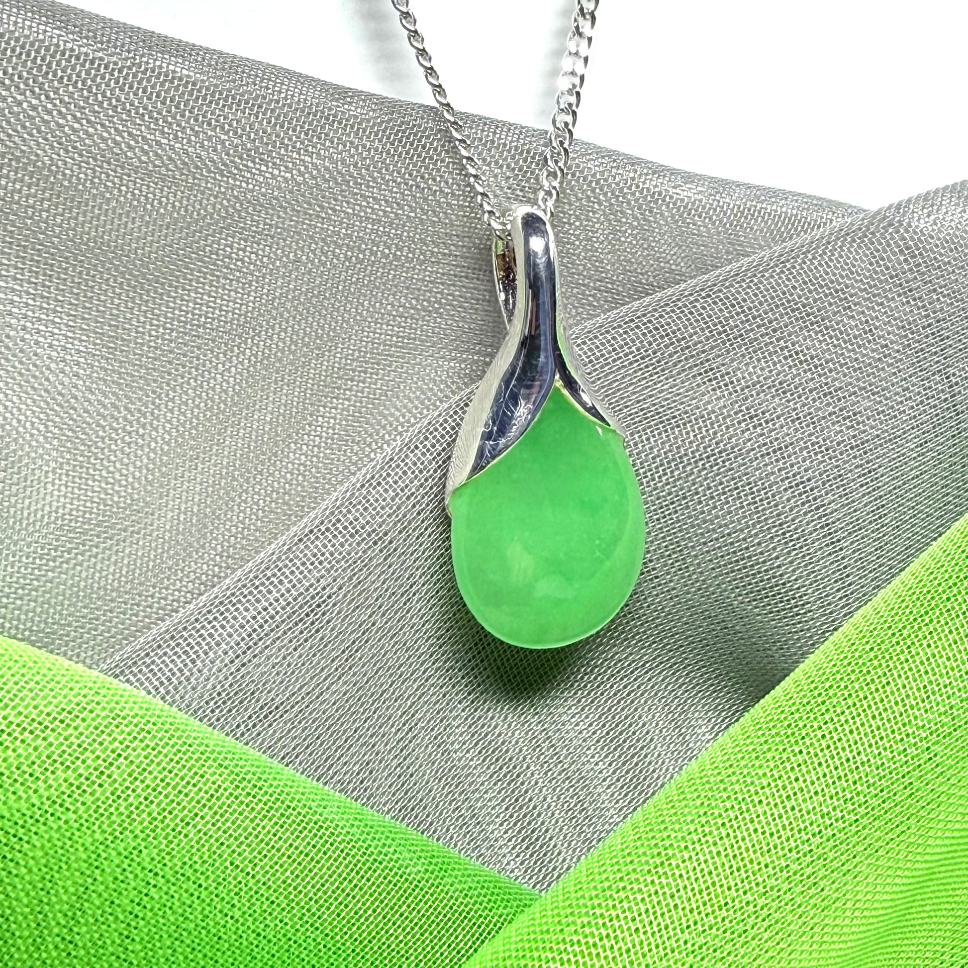 Real green jade necklace in a teardrop or pear shaped, timeless designed pendant with chain
