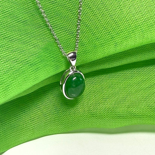 Real green jade necklace white gold oval rub over smooth setting with a chain
