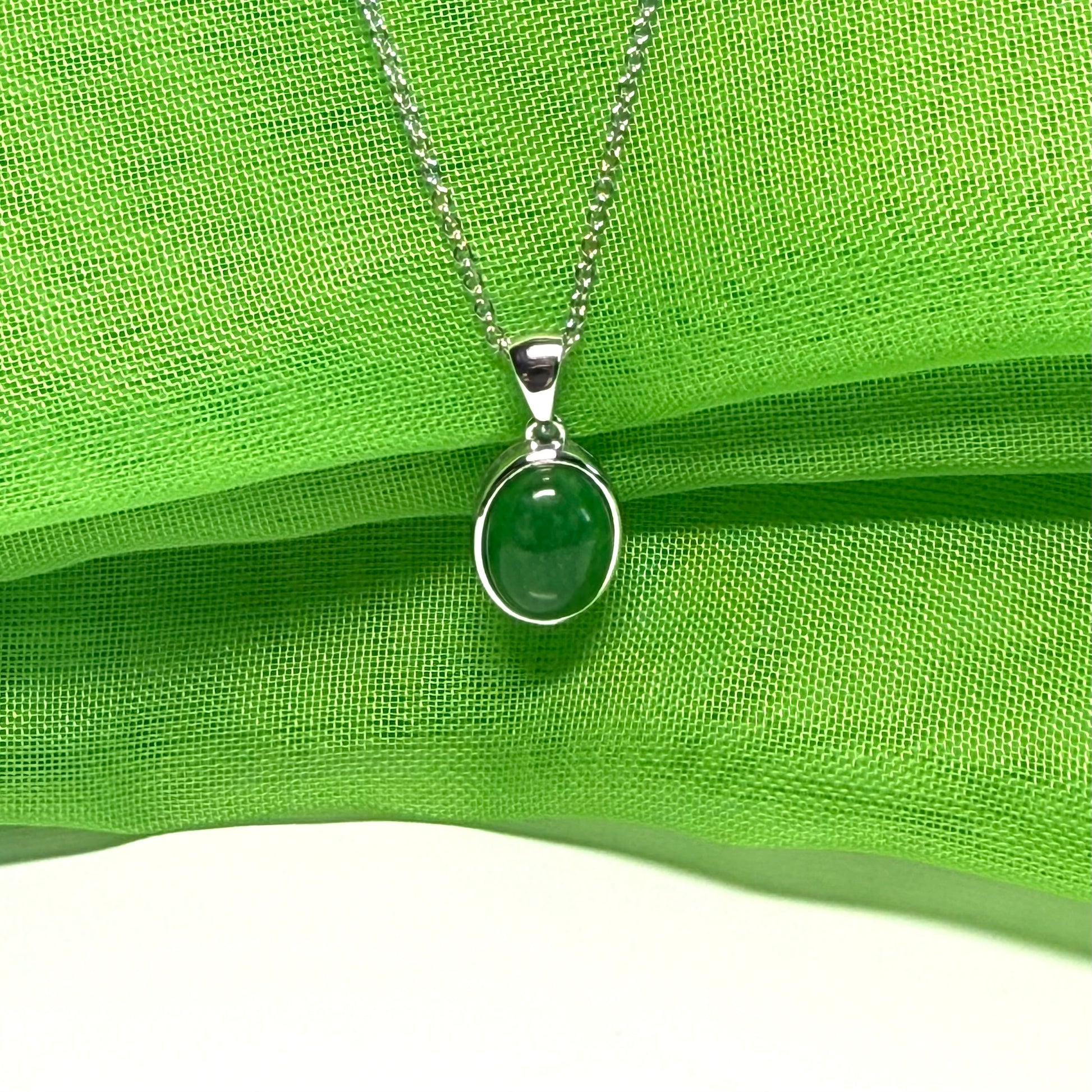 Real green jade necklace white gold oval rub over smooth setting with a chain