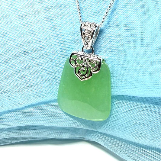 Real green jade necklace with a large shaped and patterned top pendant with chain