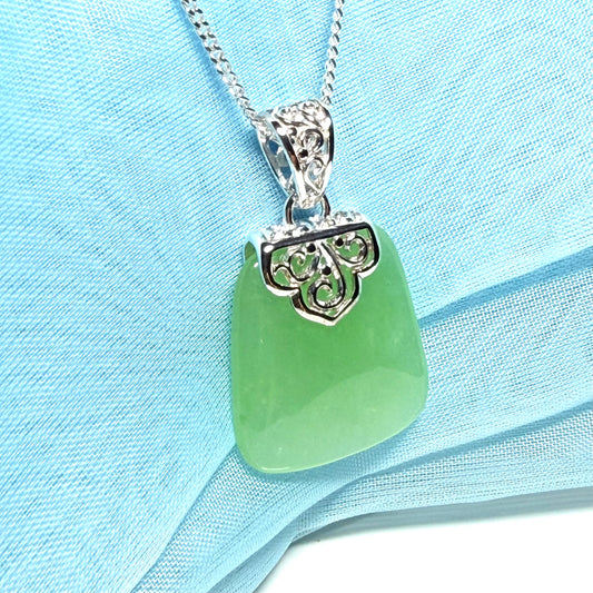 Real green jade necklace with a large shaped and patterned top pendant