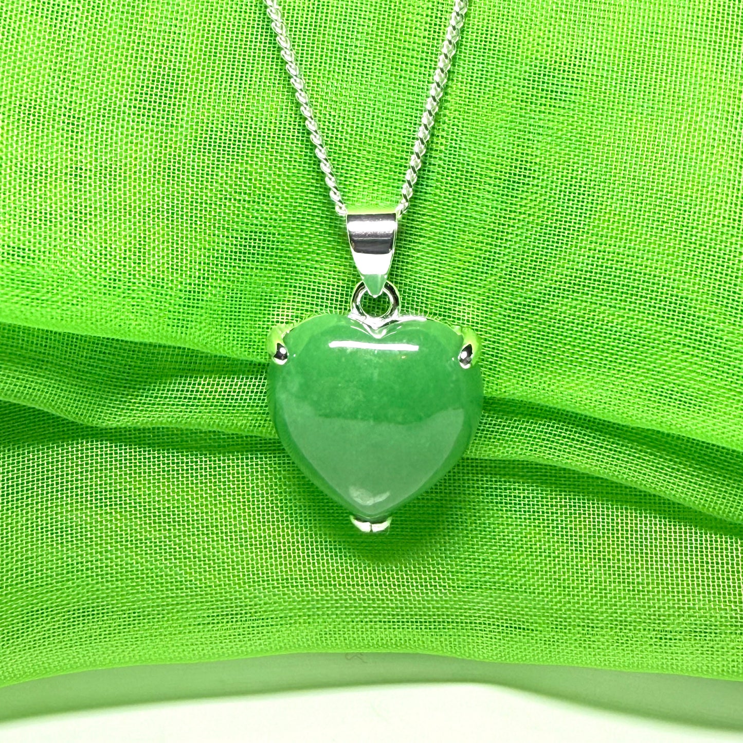 A real green jade pendant heart shaped sterling silver, a traditionally designed necklace
