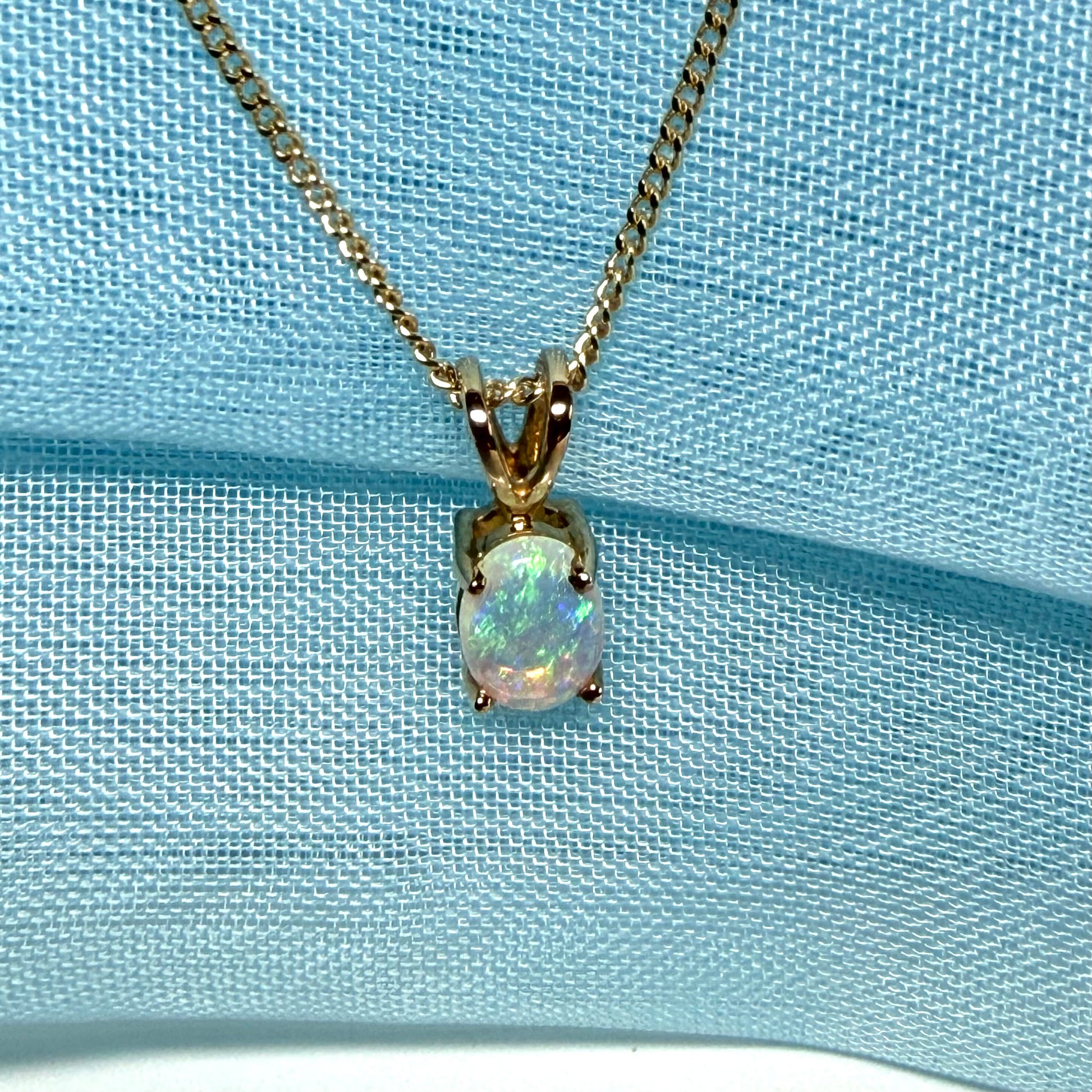 Real opal pendant oval yellow gold