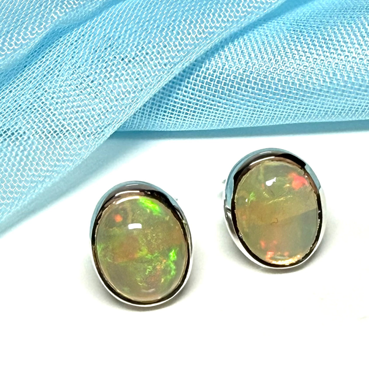 Real opal sterling silver oval shaped stud earrings