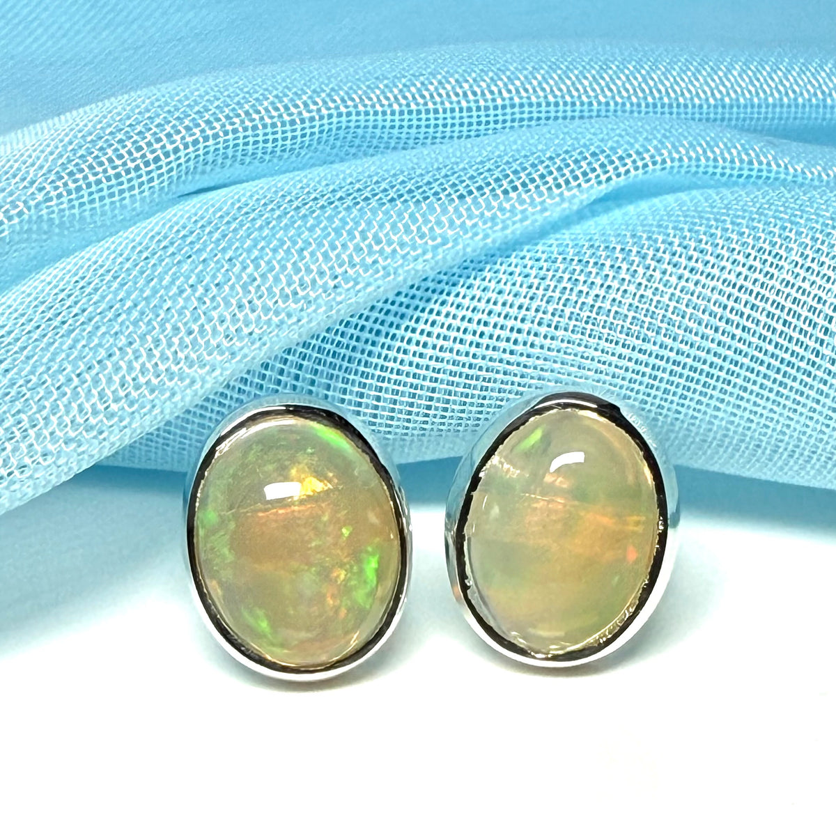 Real opal sterling silver oval shaped stud earrings