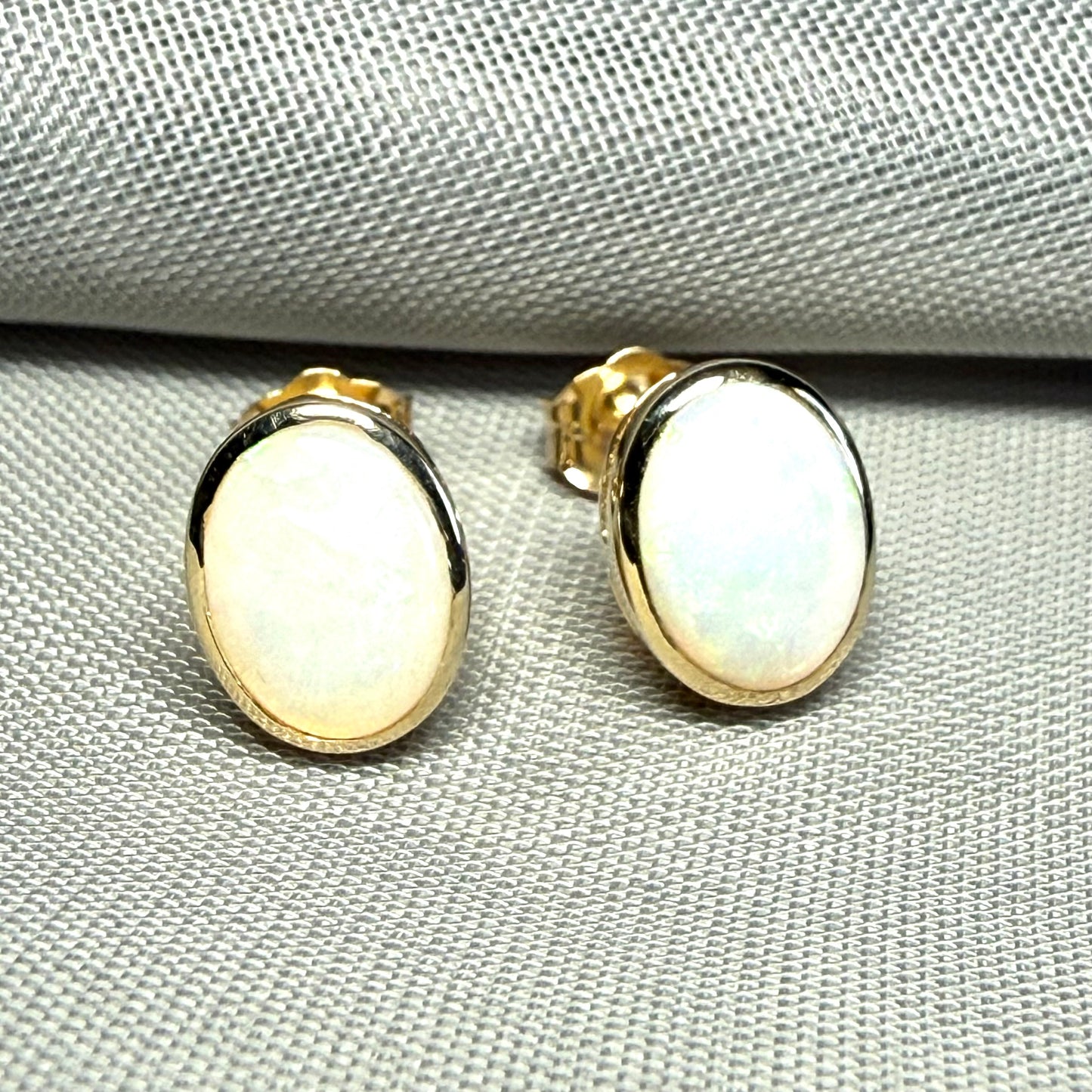 Pair of real opal yellow gold oval stud earrings