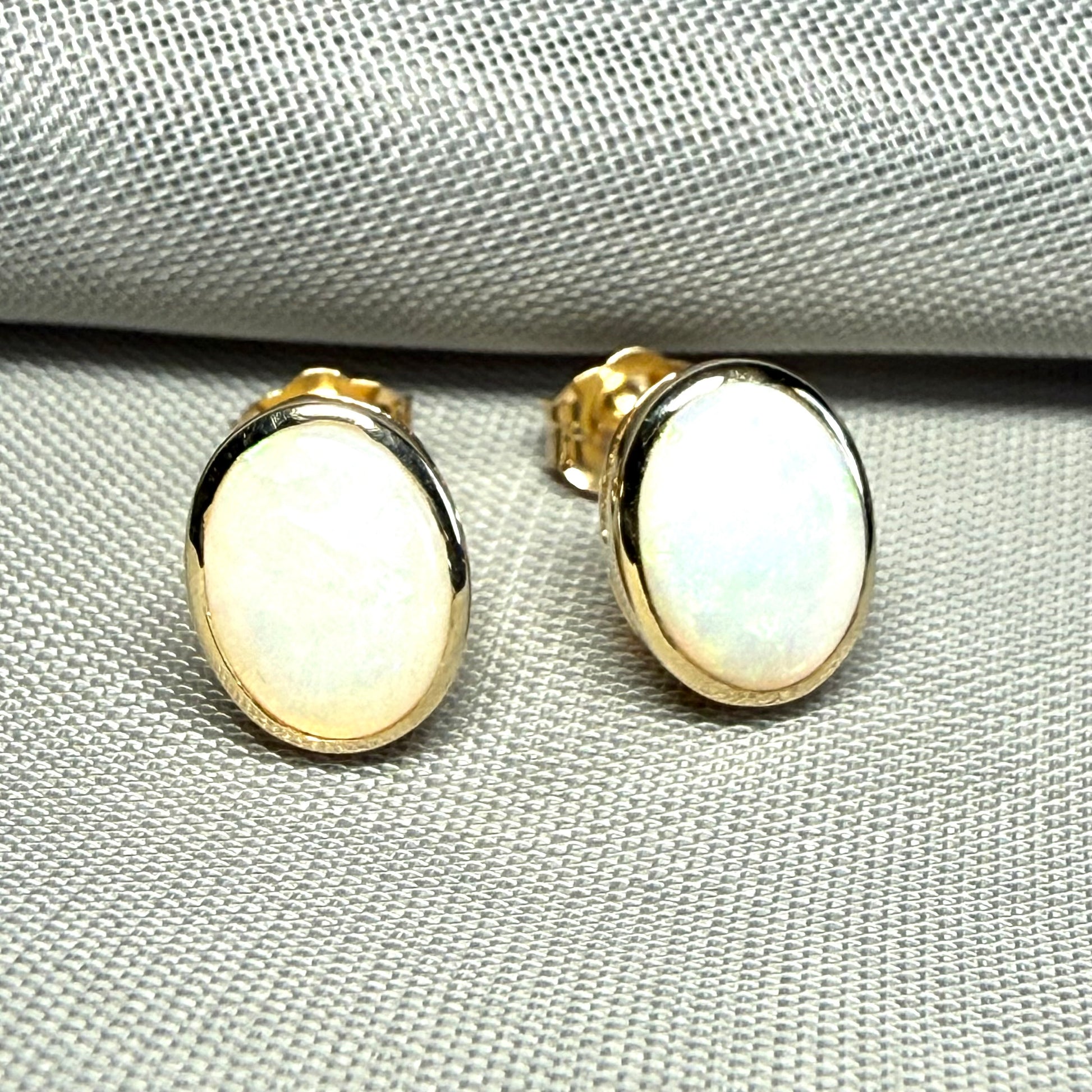 Pair of real opal yellow gold oval stud earrings
