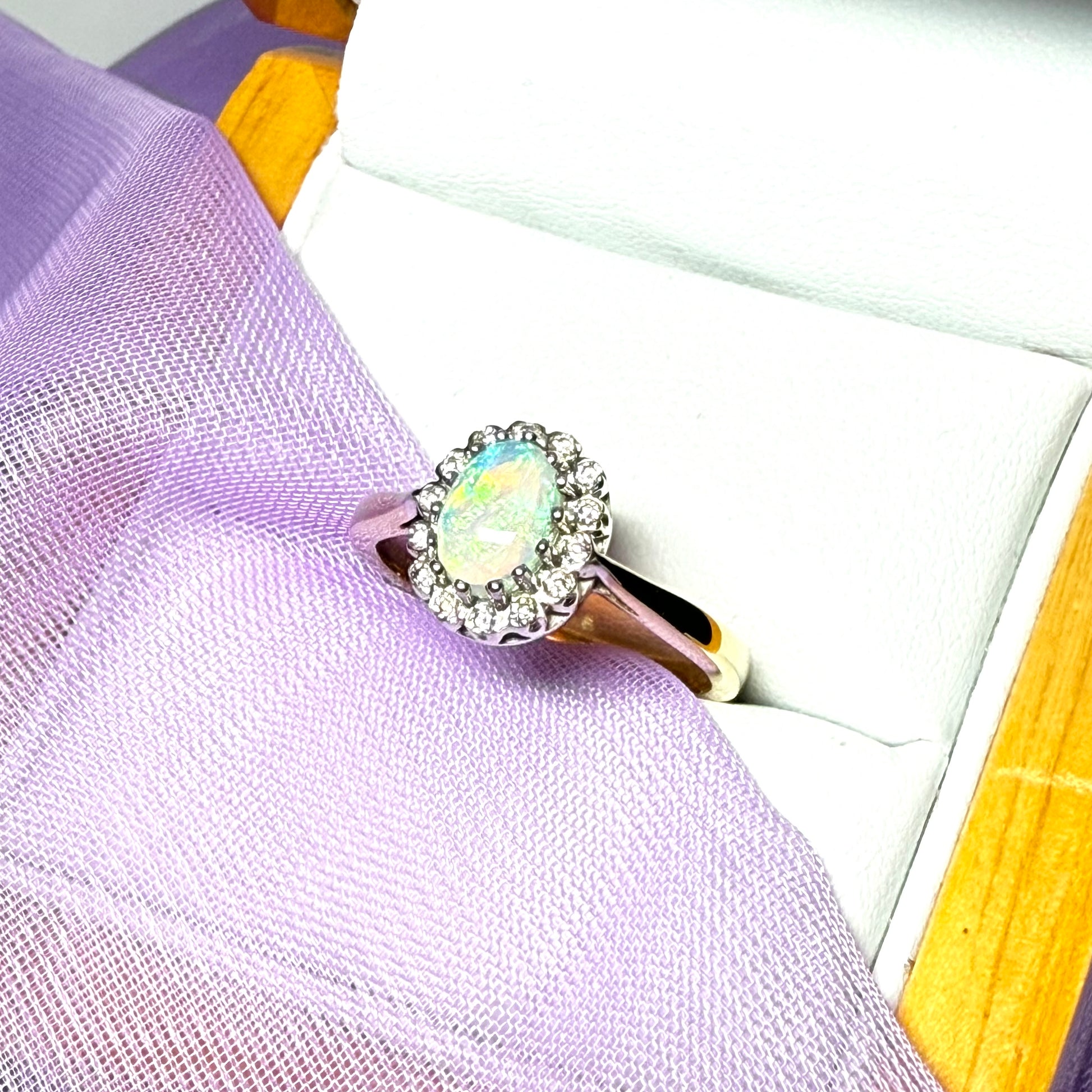 Real oval opal and diamond yellow gold cluster ring