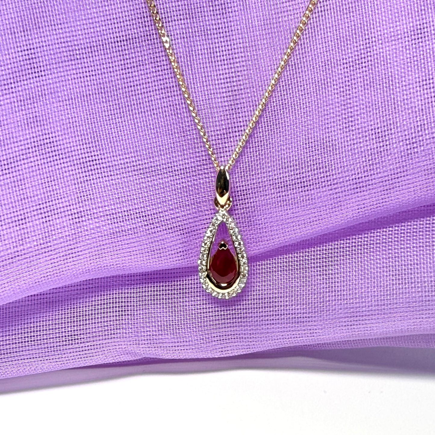 Real red pear shaped ruby and diamond pierced necklace yellow gold
