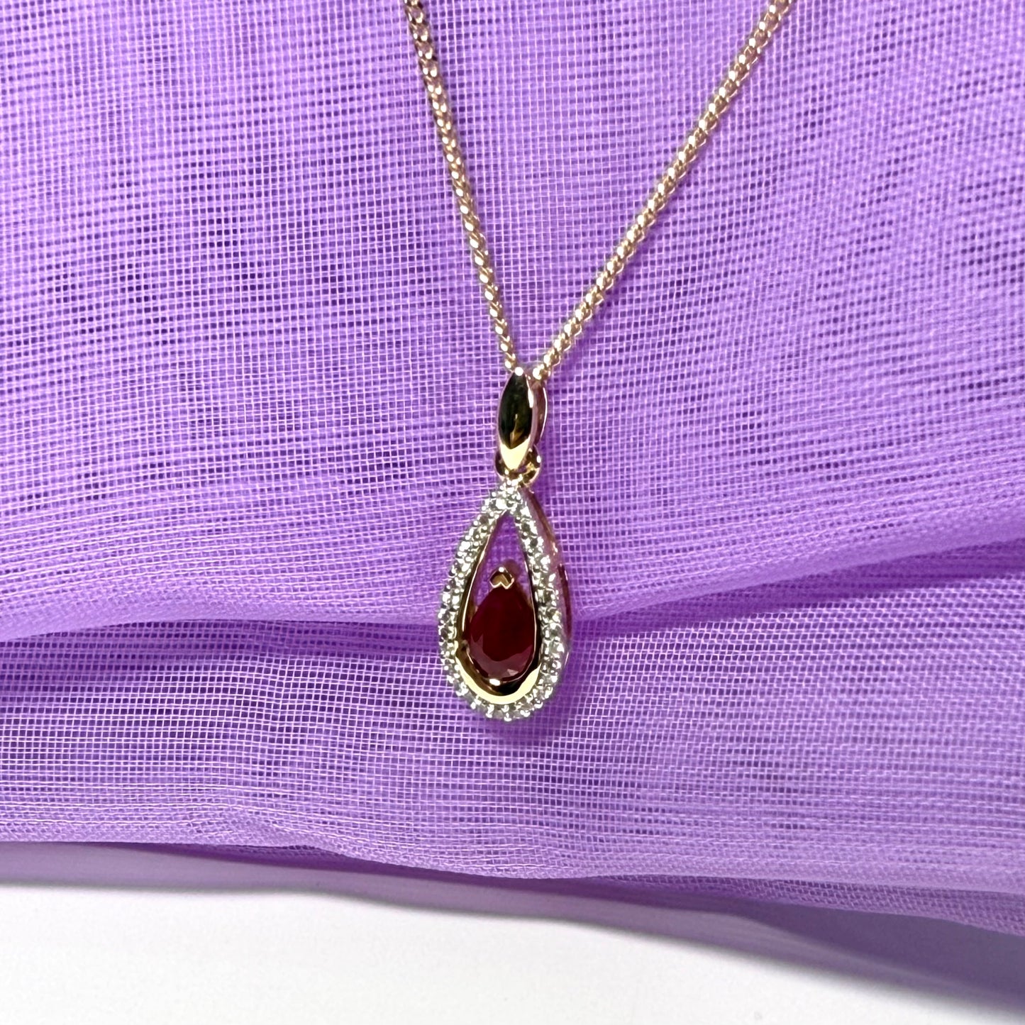 Real red pear shaped ruby and diamond pierced necklace yellow gold