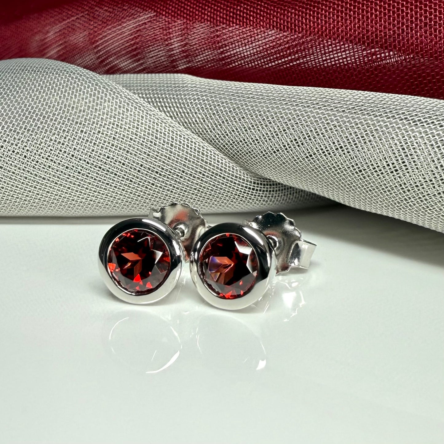 Real red round garnet stud earrings smooth rubbed over edges