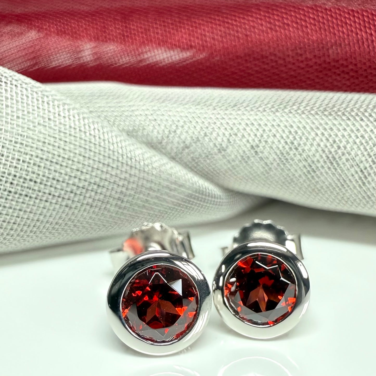Real red round garnet stud earrings smooth rubbed over edges