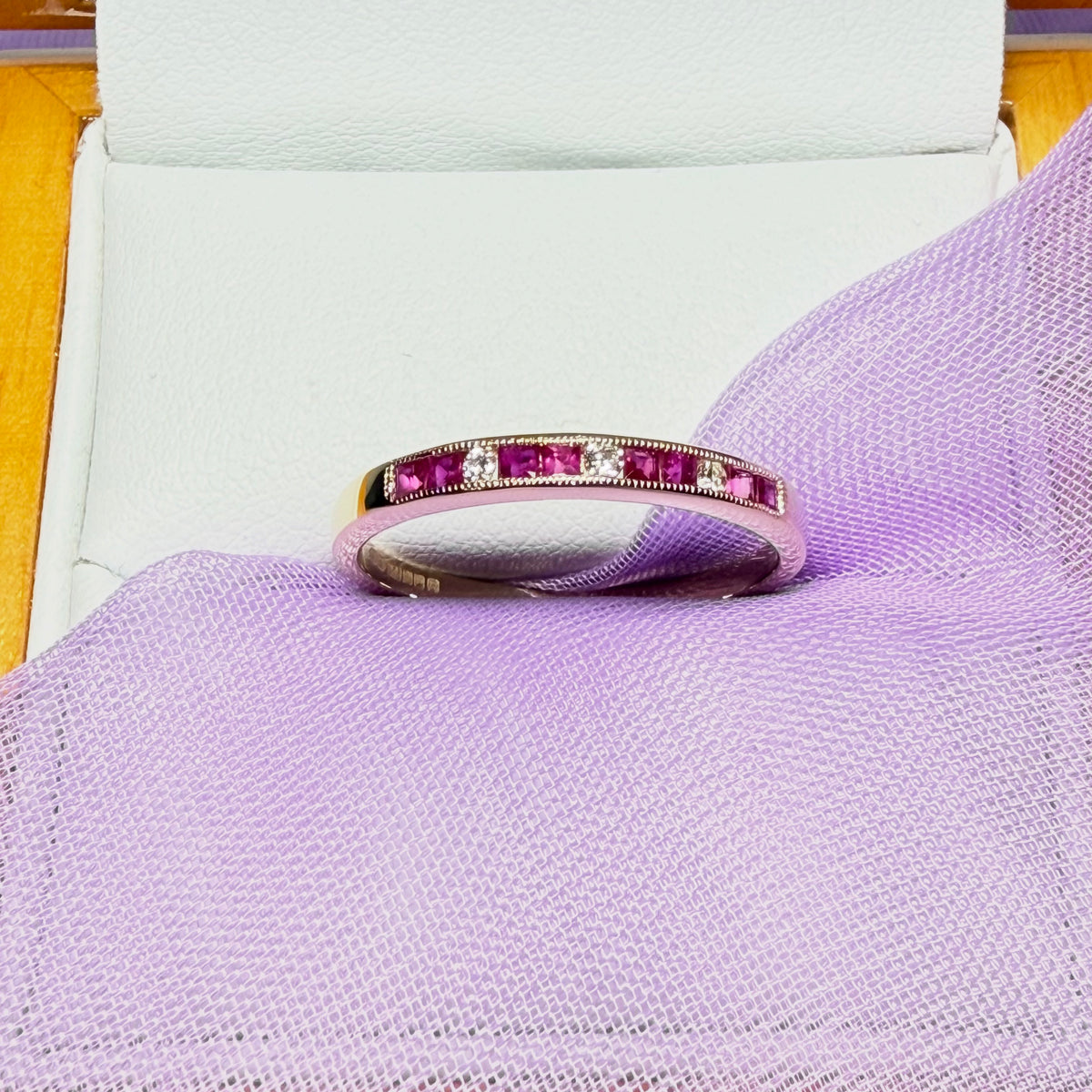 Real red ruby and diamond channel set eternity ring yellow gold