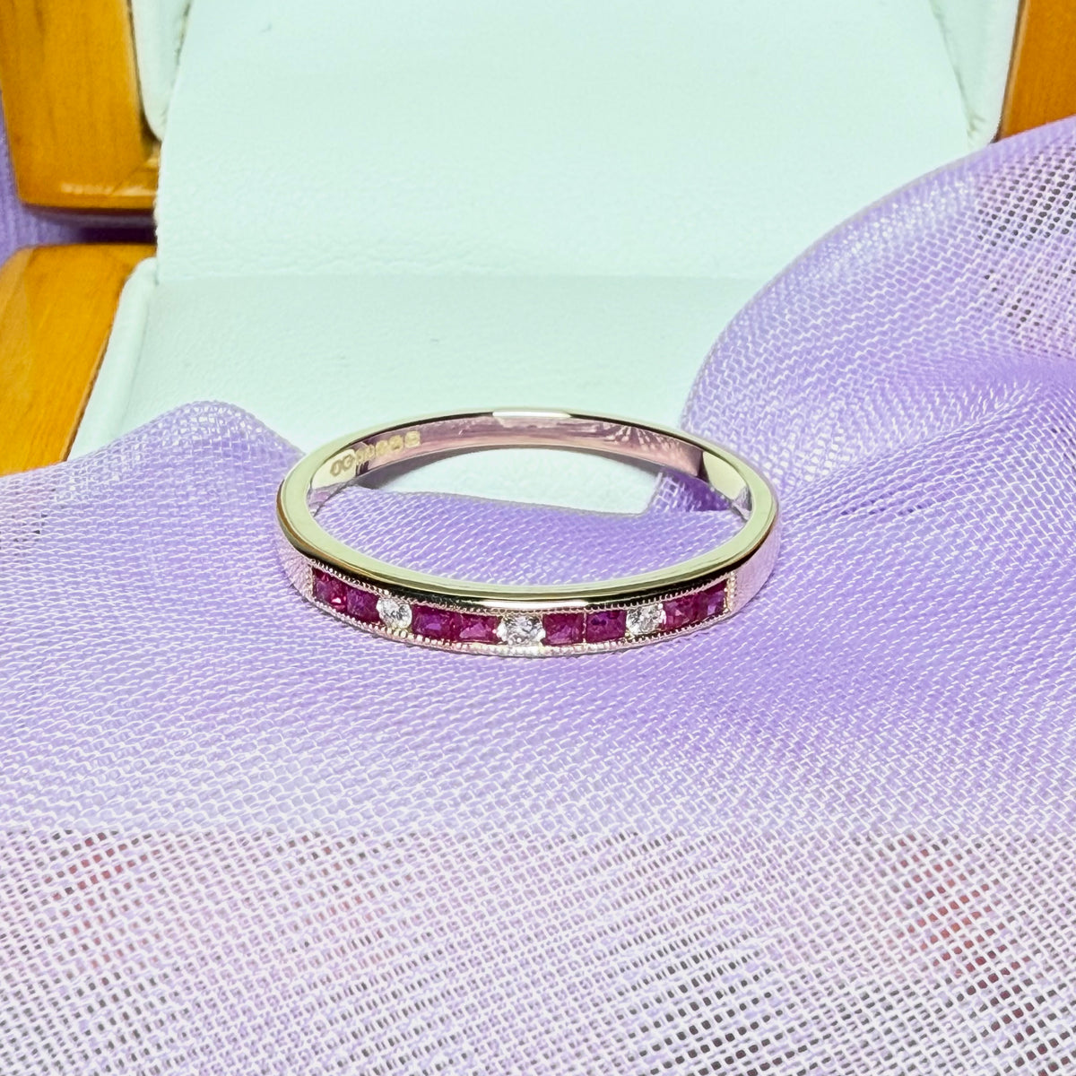 Real red ruby and diamond channel set eternity ring yellow gold