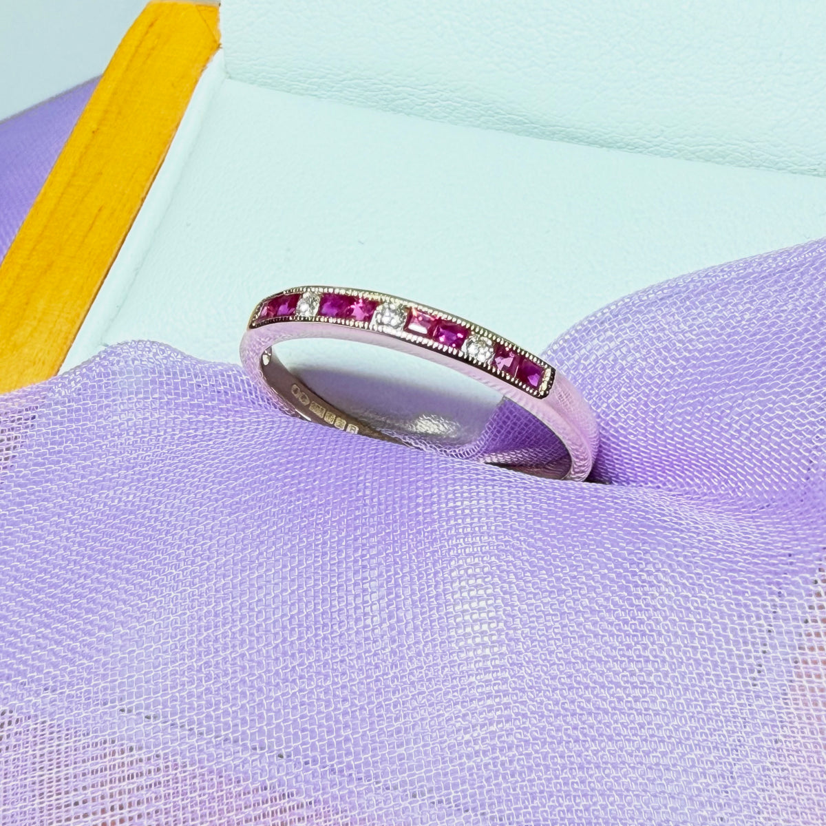 Real red ruby and diamond channel set eternity ring yellow gold