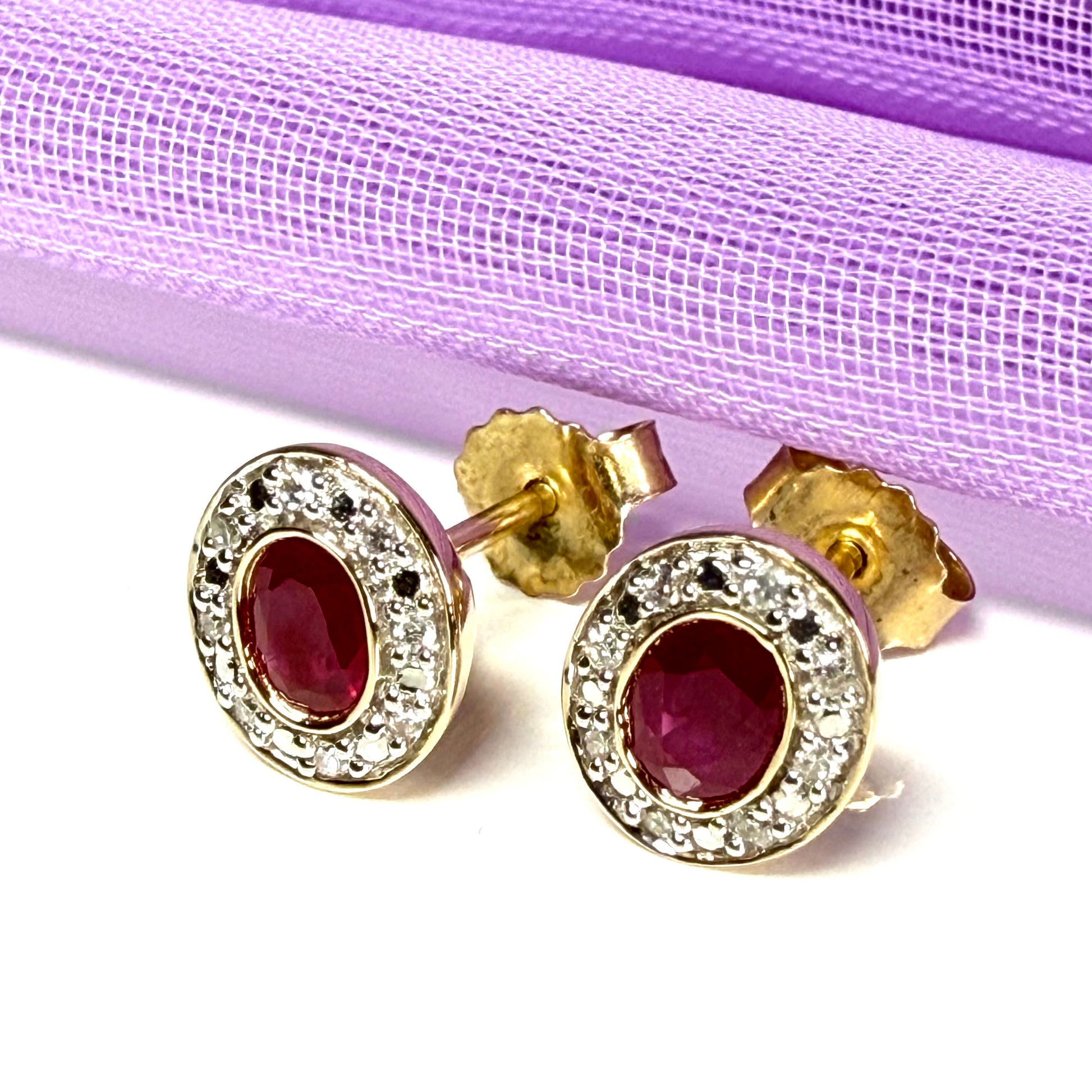 Real ruby and diamond oval shaped cluster stud earrings yellow gold