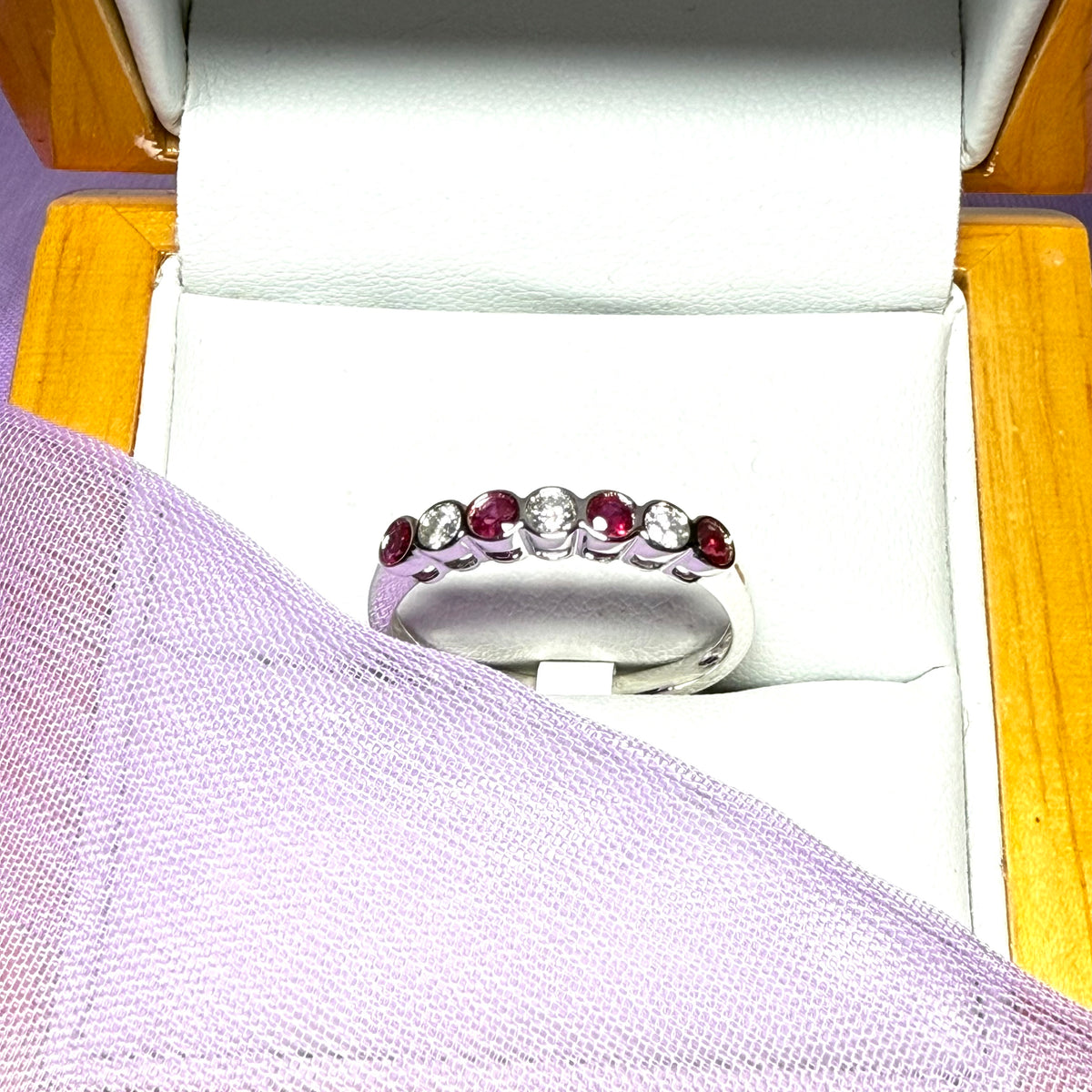 A real ruby and diamond white gold eternity ring smooth setting
