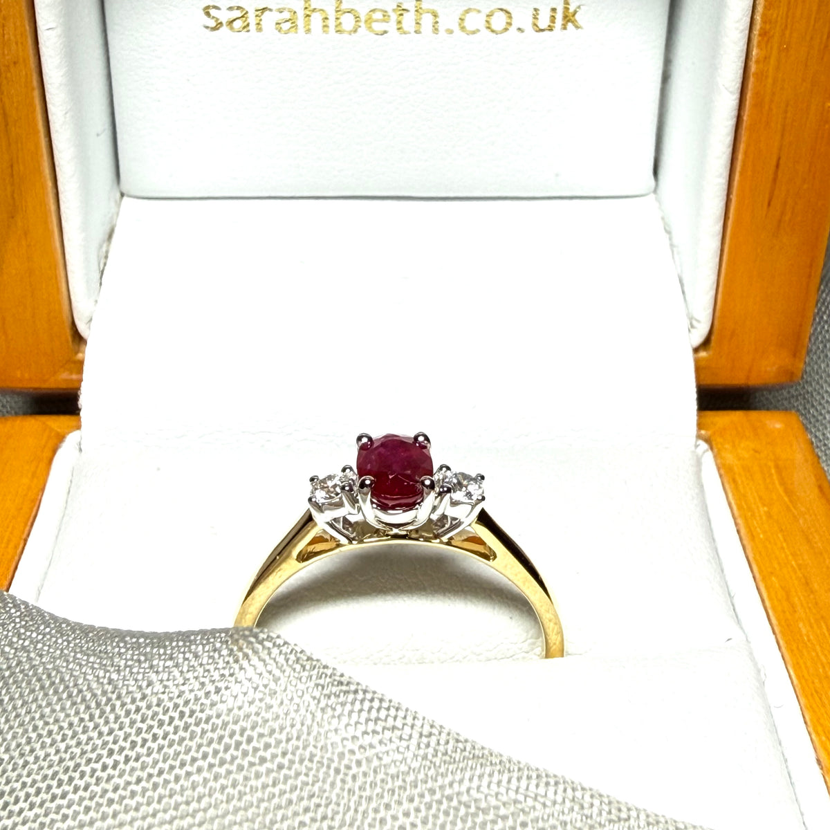Ruby and diamond yellow gold three stone trilogy ring