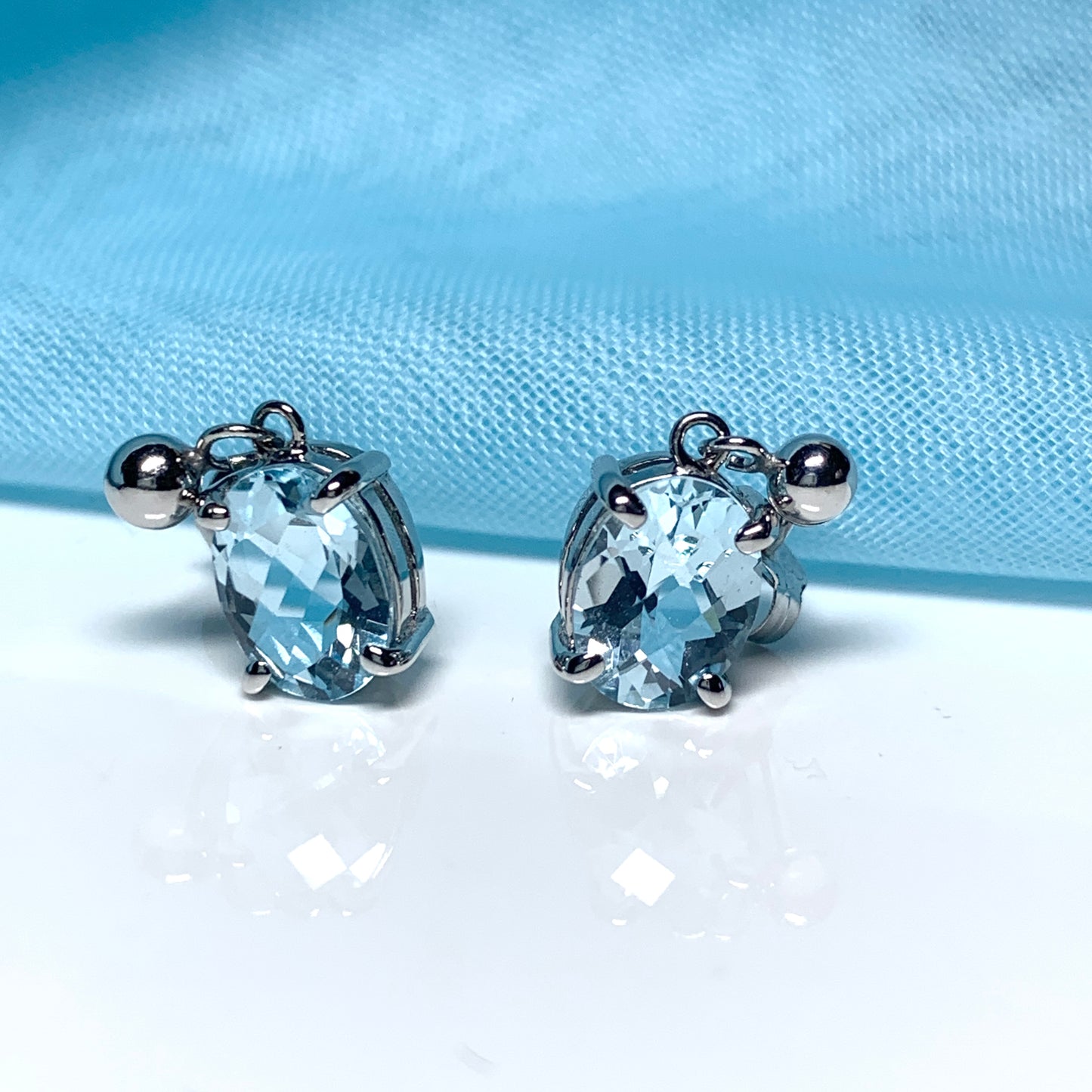 Blue topaz white gold oval drop earrings