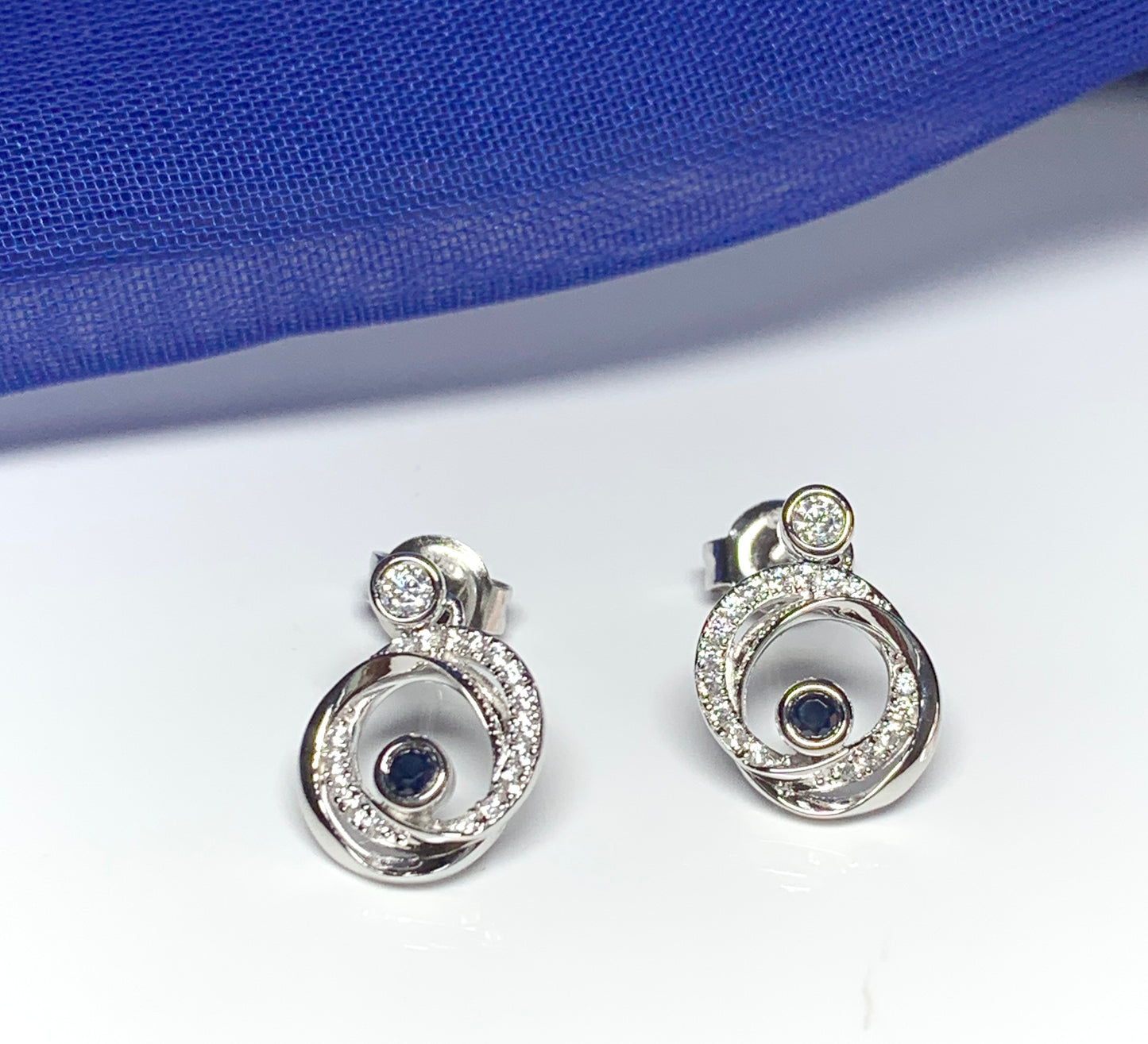 Real blue sapphire and cubic zirconia round swirl stud earrings