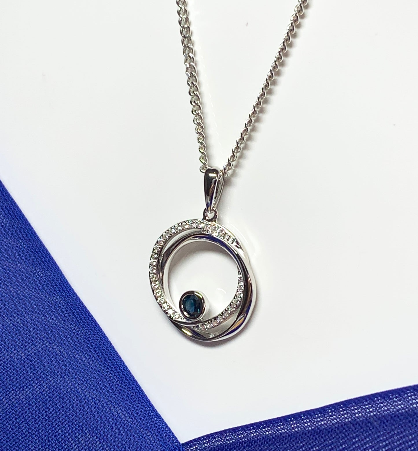 Real blue sapphire and cubic zirconia round necklace swirl pendant