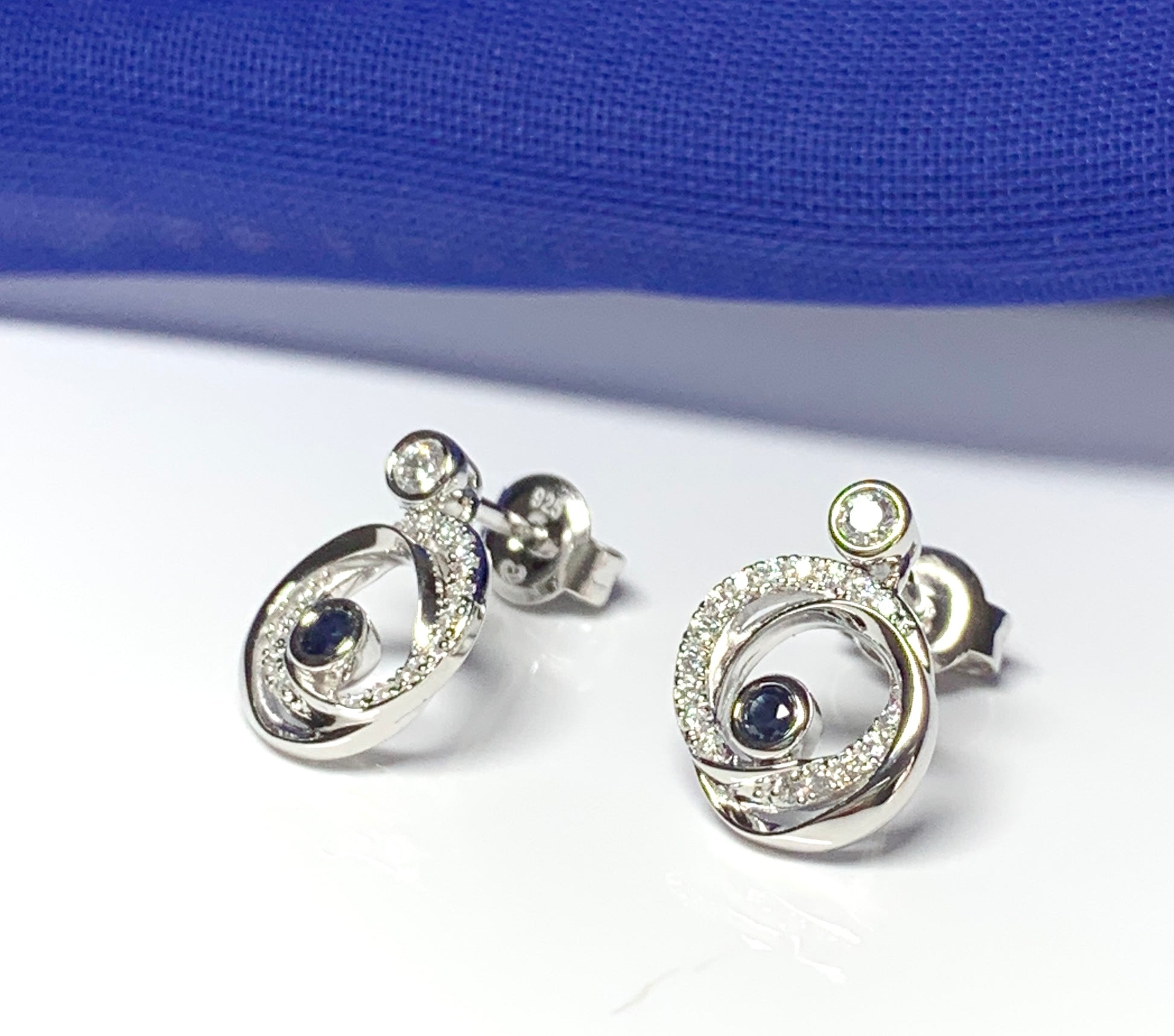 Real blue sapphire and cubic zirconia round swirl stud earrings