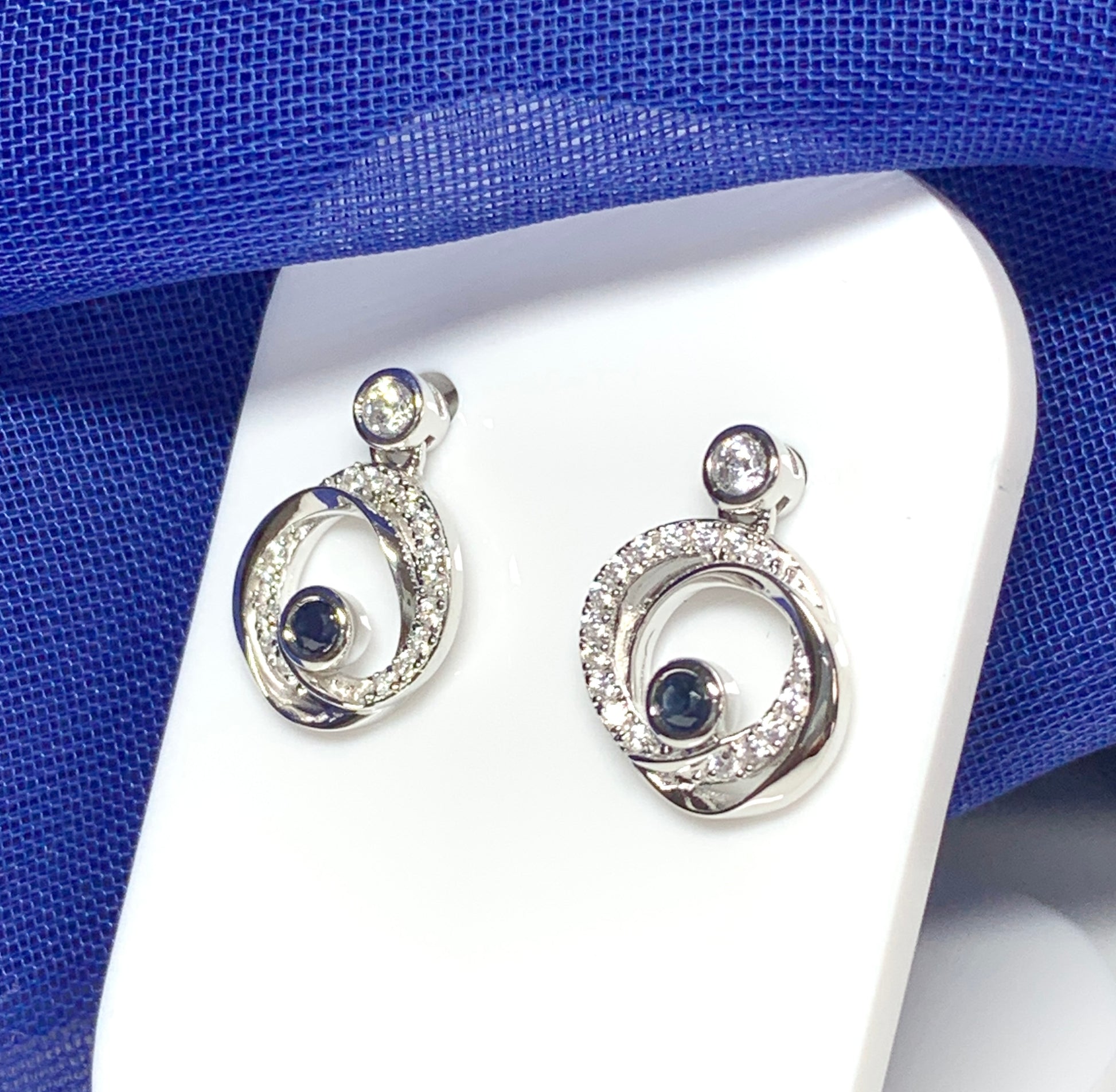 Real blue sapphire and cubic zirconia round swirl stud earrings