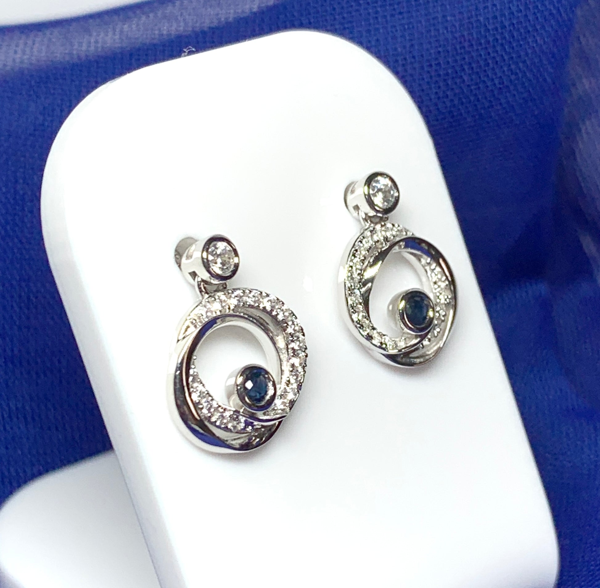 Real blue sapphire and cubic zirconia round swirl stud earrings