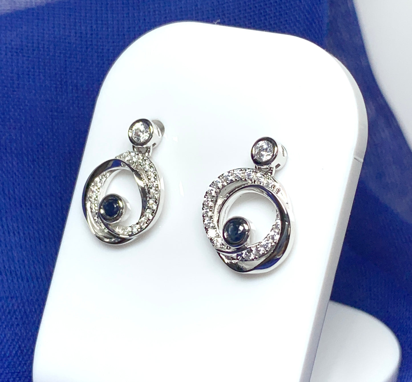 Real blue sapphire and cubic zirconia round swirl stud earrings