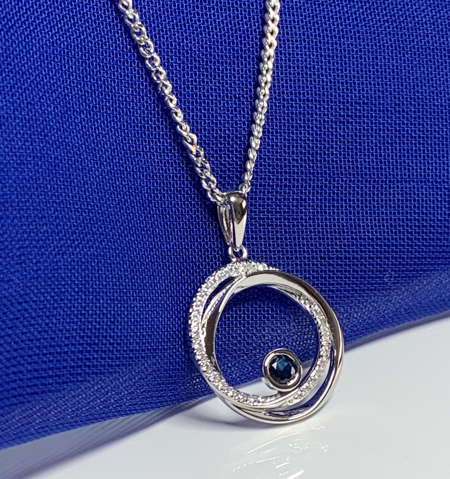 Real blue sapphire and cubic zirconia round necklace swirl pendant