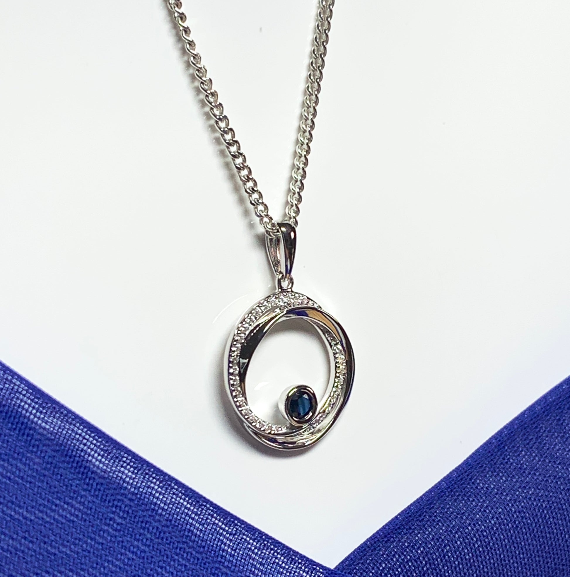 Real blue sapphire and cubic zirconia round necklace swirl pendant