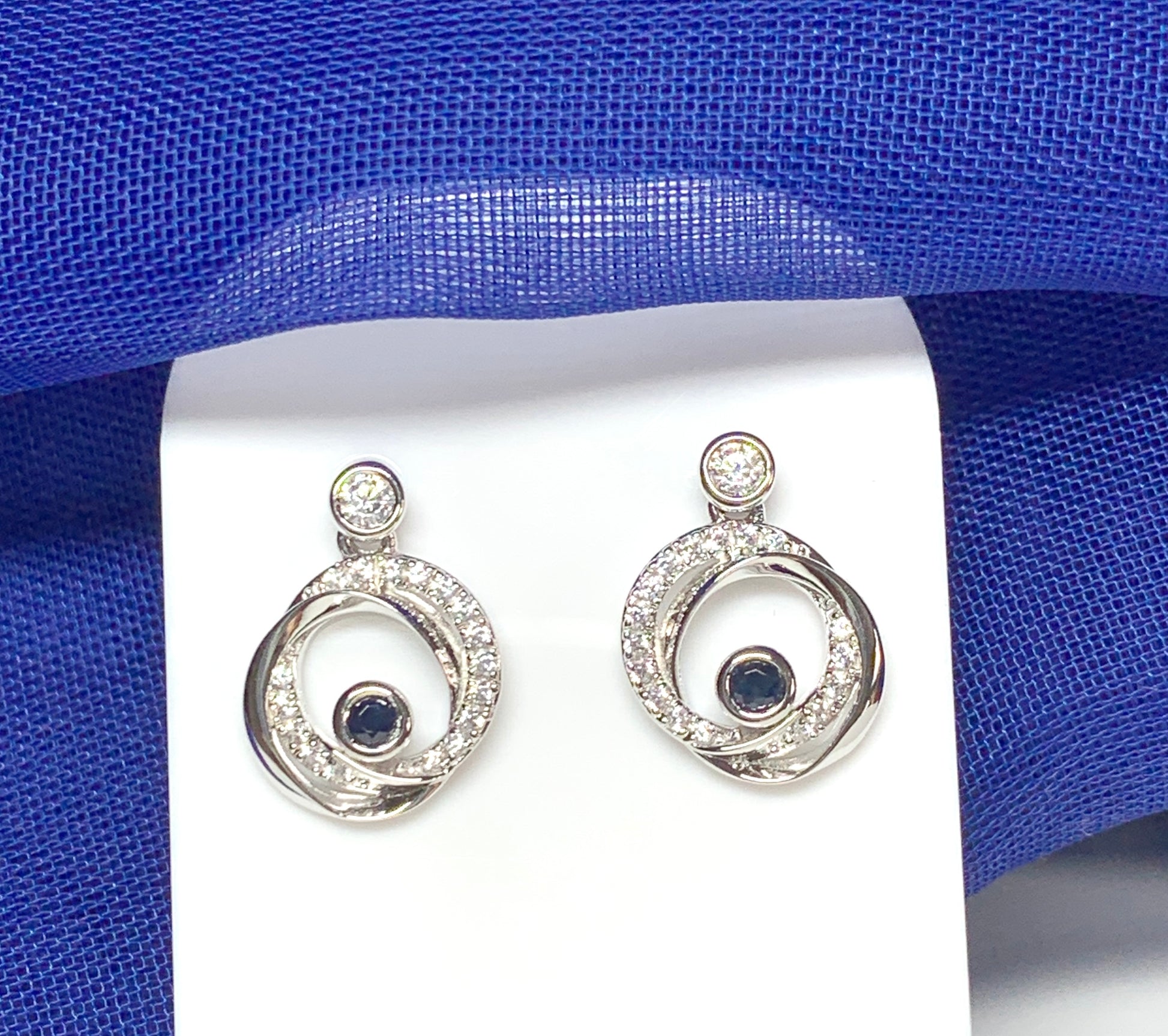 Real blue sapphire and cubic zirconia round swirl stud earrings