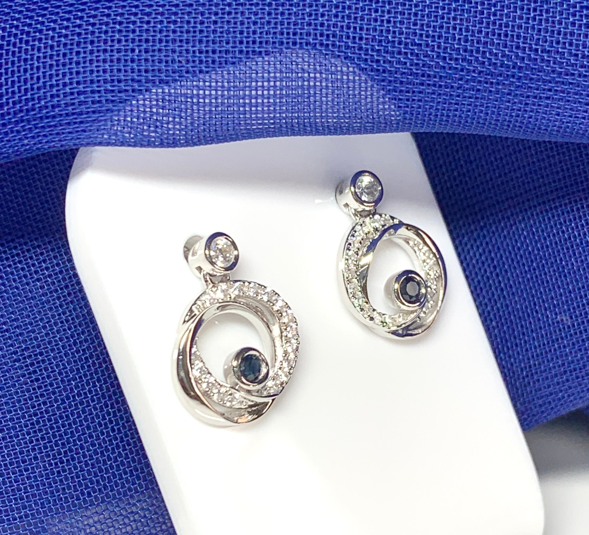 Real blue sapphire and cubic zirconia round swirl stud earrings