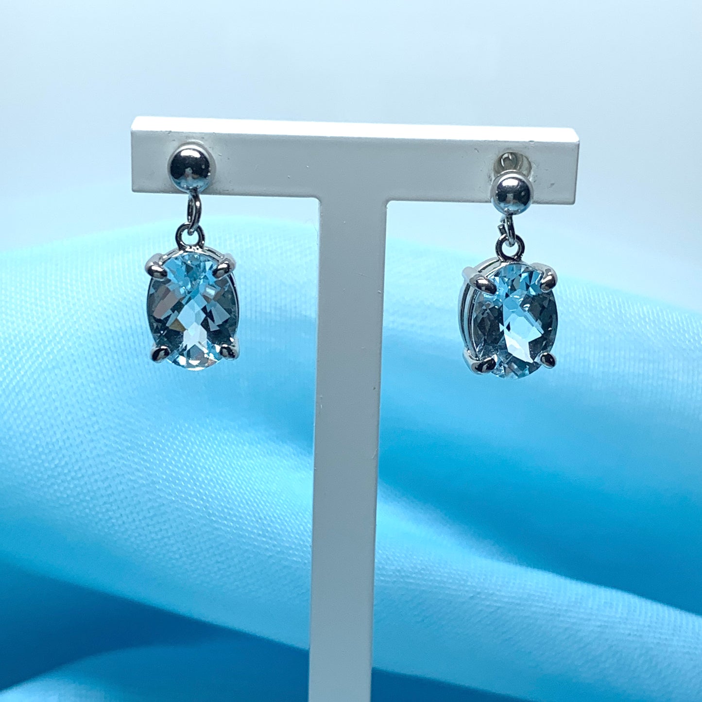 Blue topaz white gold oval drop earrings