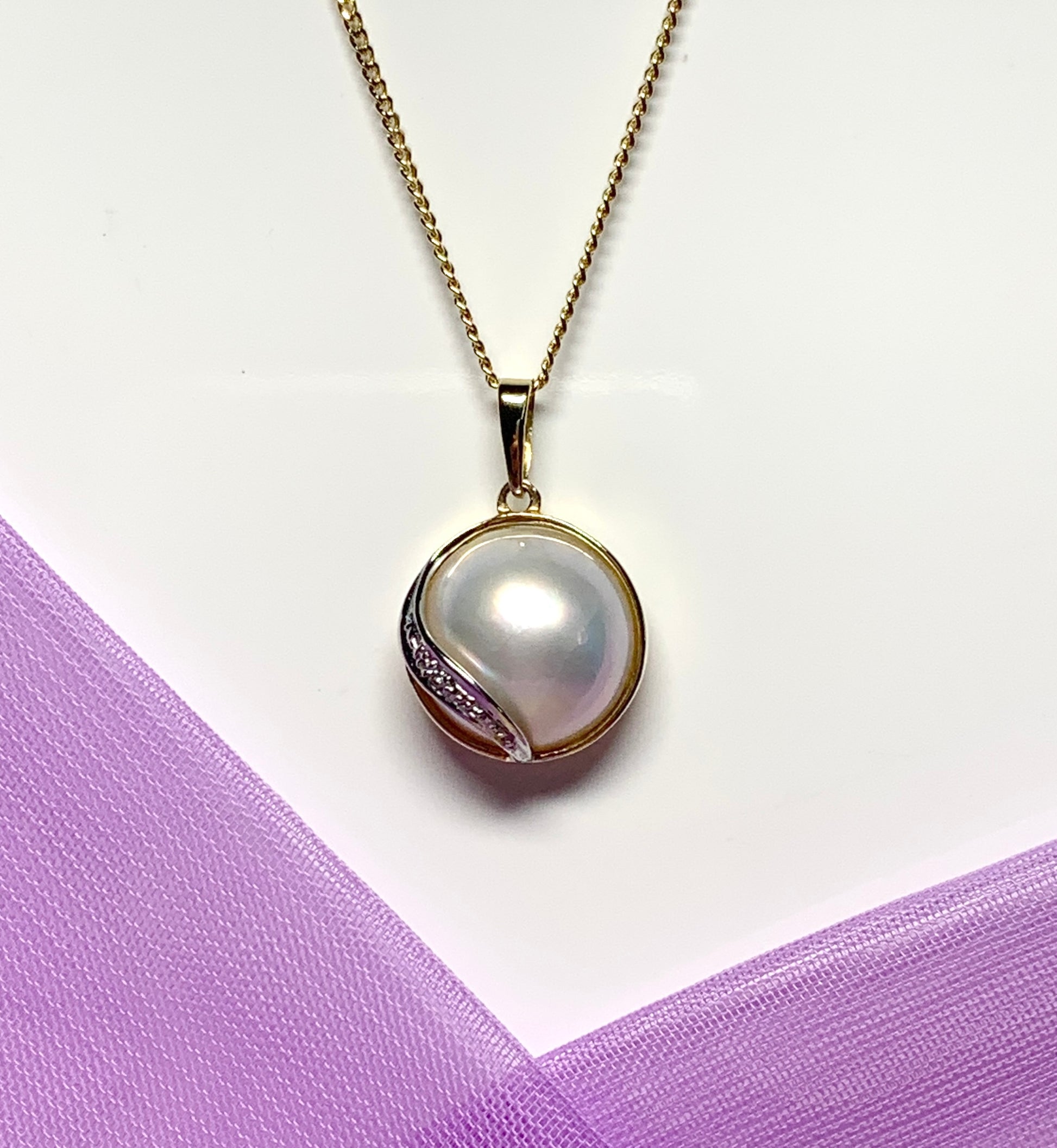 Real cultured mabe pearl and diamond pendant yellow gold
