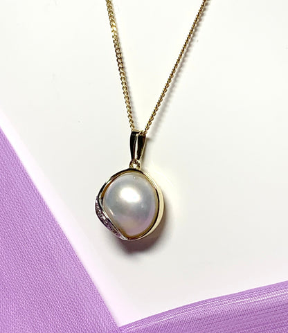 Real cultured mabe pearl and diamond pendant yellow gold