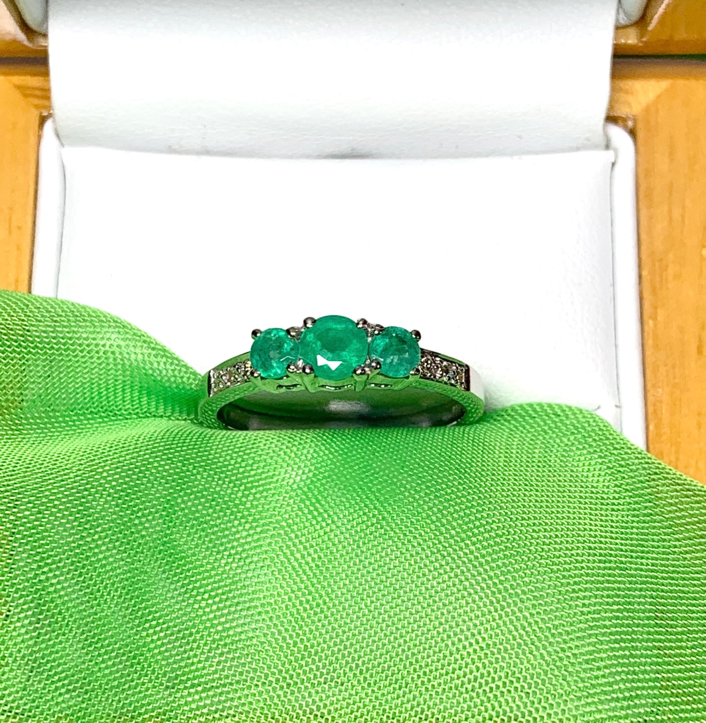 Real emerald and diamond three stone trilogy ring white gold