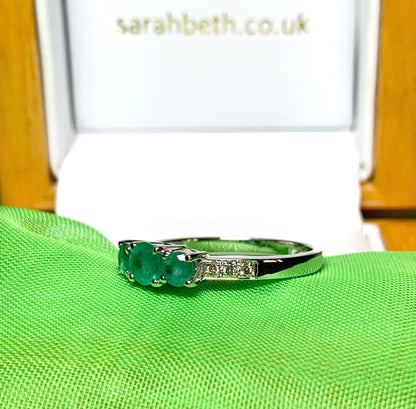 Real emerald and diamond three stone trilogy ring white gold