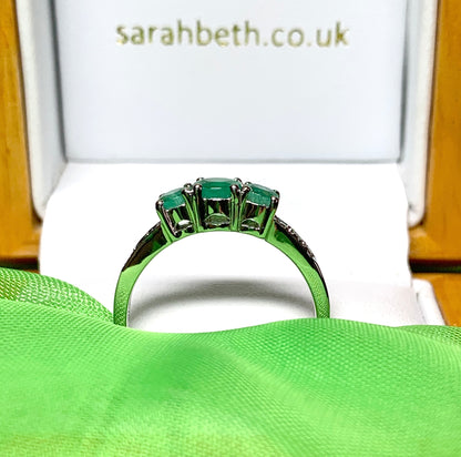 Real emerald and diamond three stone trilogy ring white gold