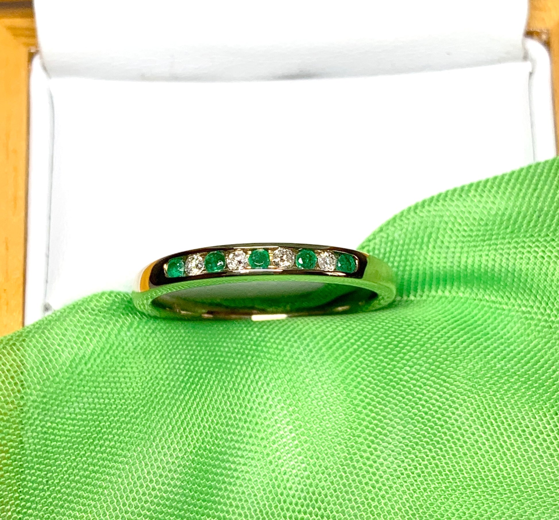 Green real emerald and diamond yellow gold channel set eternity ring