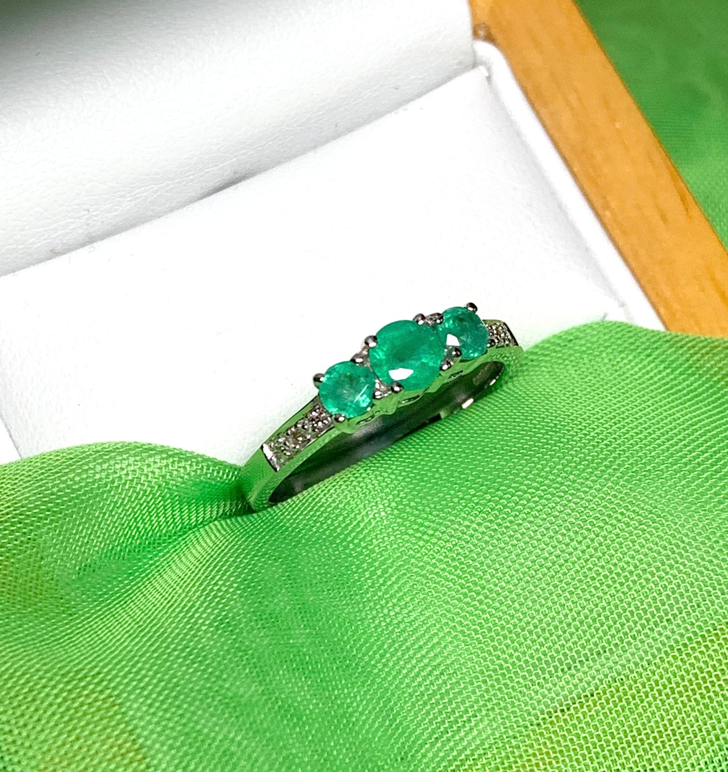 Real emerald and diamond three stone trilogy ring white gold