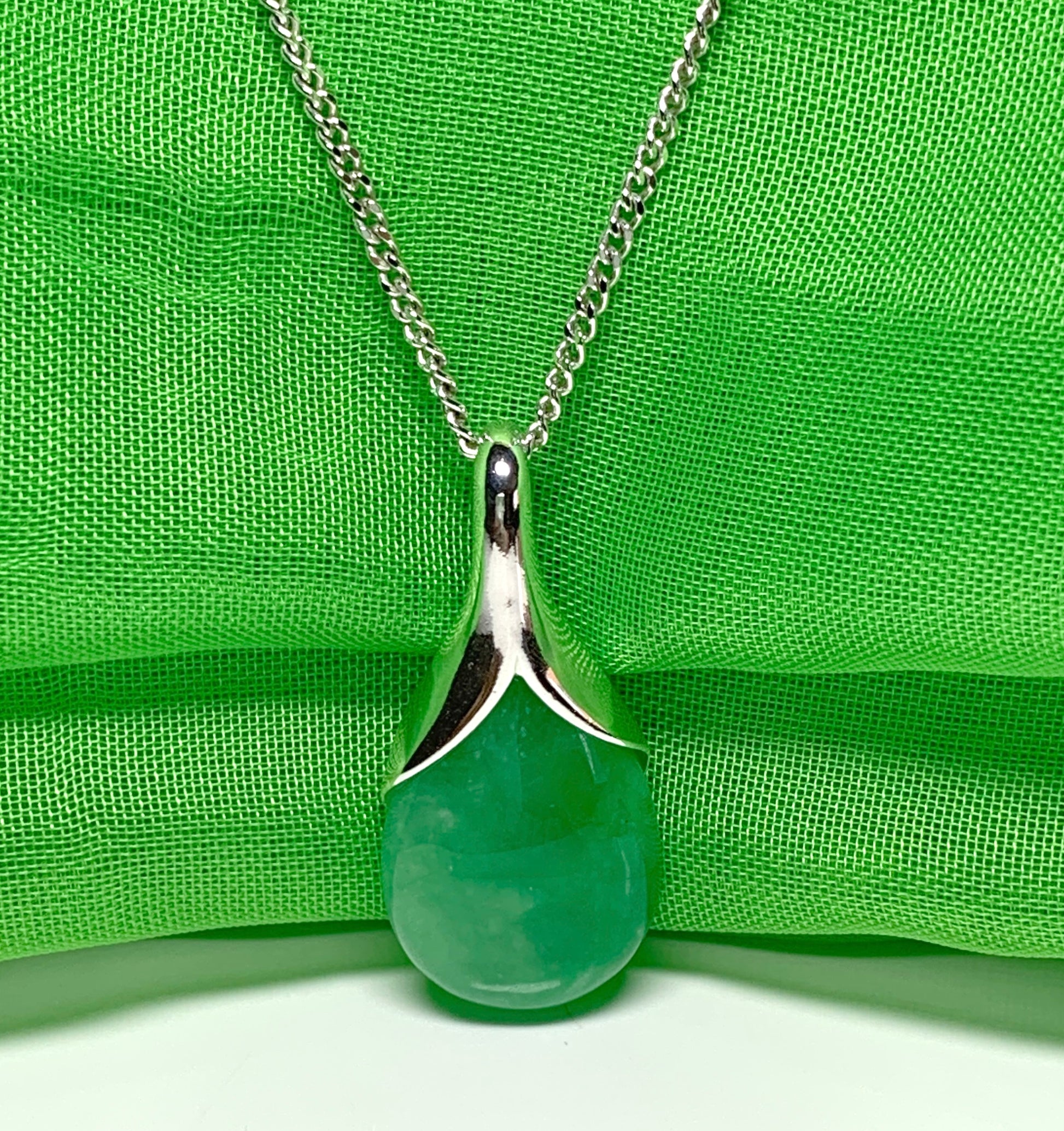 Real green jade necklace in a tear drop or pear shaped sterling silver pendant