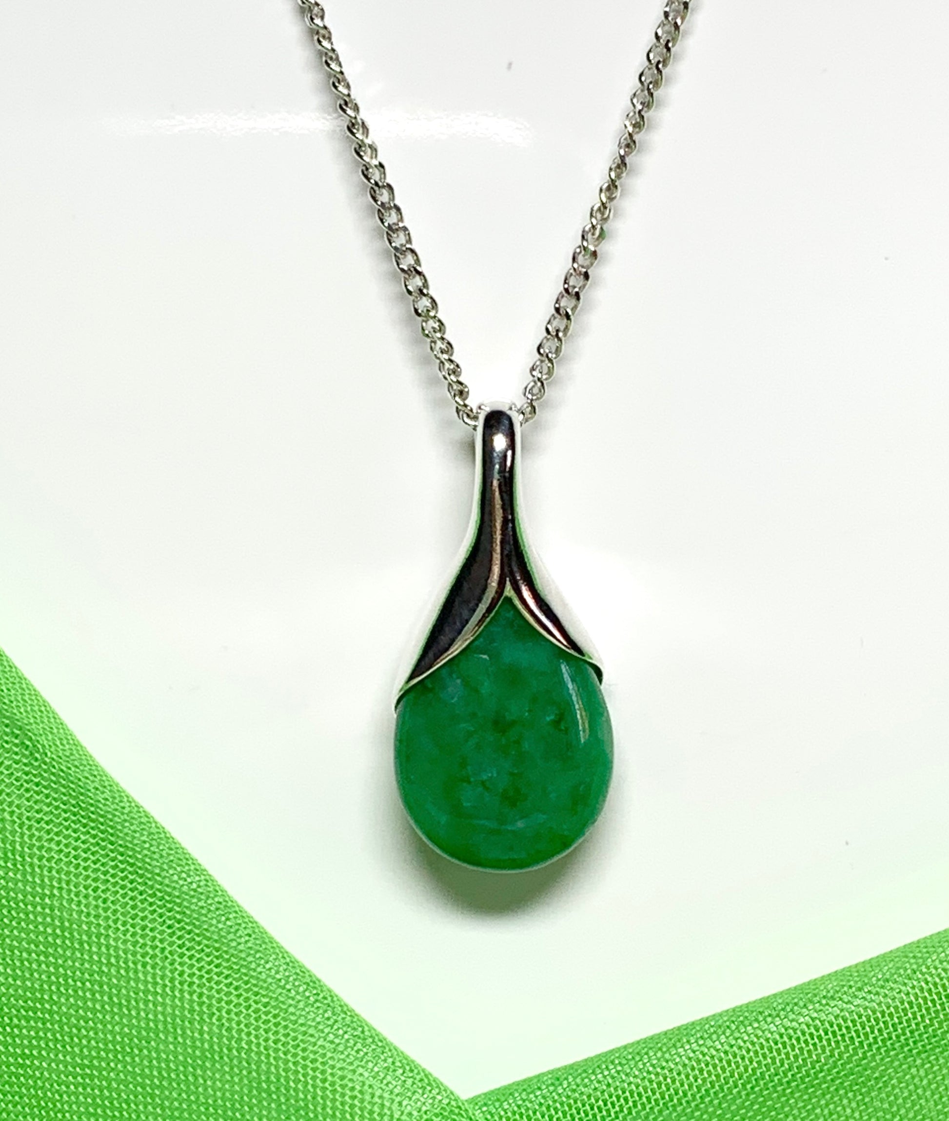 Real green jade necklace in a pear or tear drop shaped sterling silver pendant