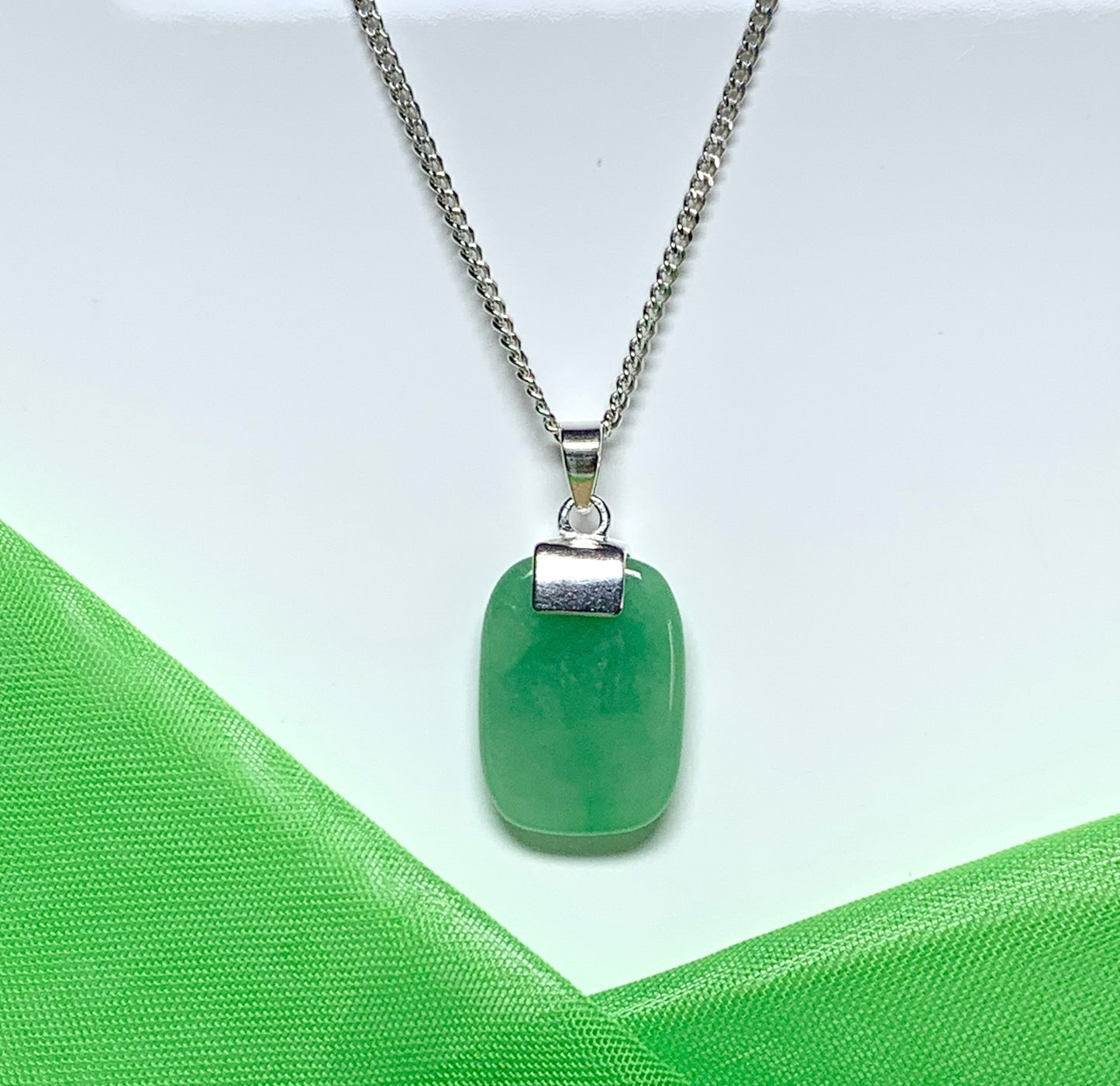 Necklace having a real green jade sterling silver cushion shaped pendant