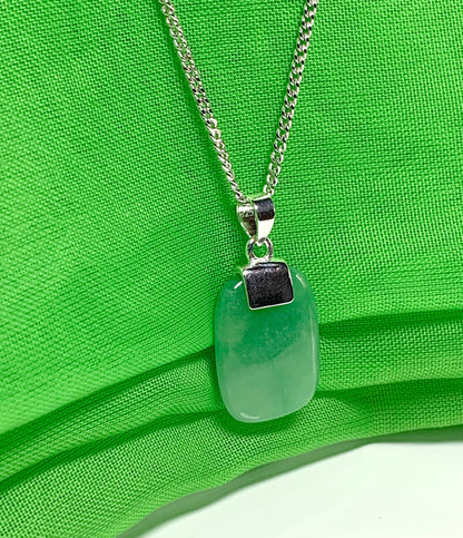 Necklace having a real green jade sterling silver cushion shaped pendant