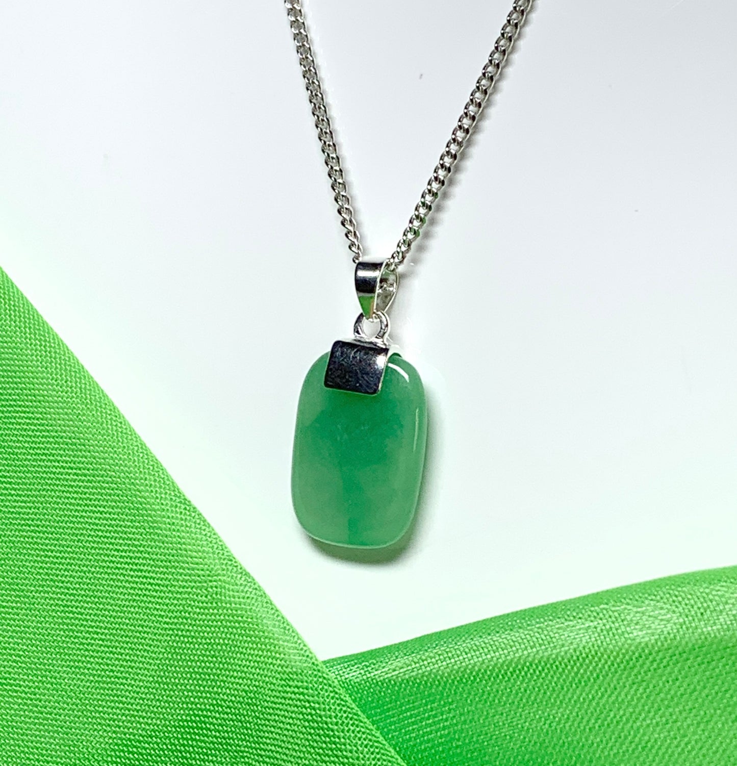 Necklace having a real green jade sterling silver cushion shaped pendant