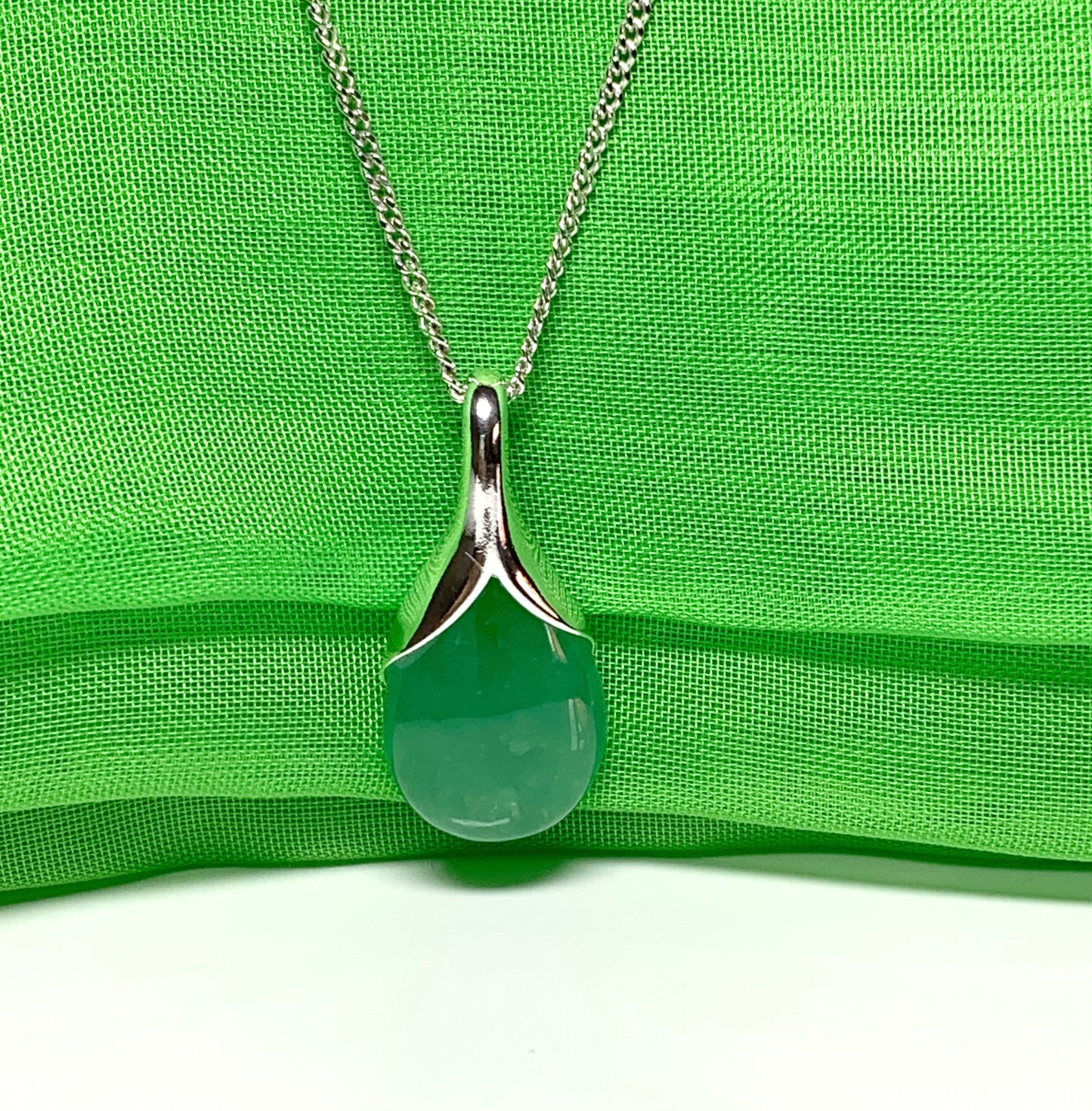 Real green jade necklace in a pear shaped sterling silver teardrop shape